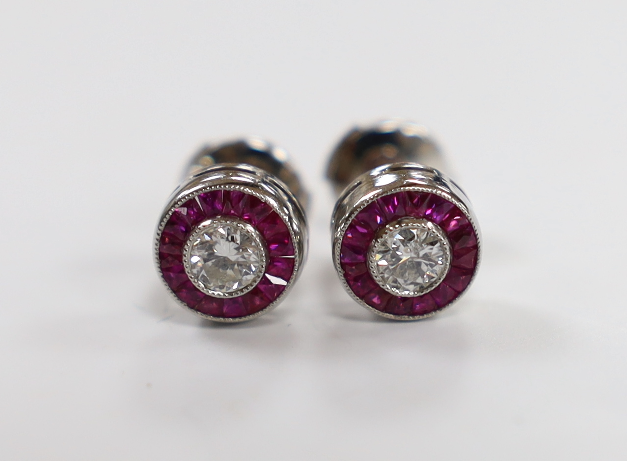 A pair of white metal, ruby and diamond set cluster target earrings, 8mm, gross weight 3.7 grams, the 'butterflies' stamped PT 950.